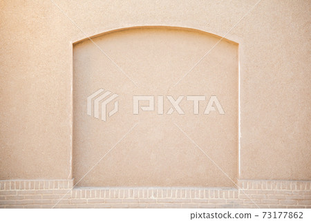 old beige stucco wall with decorated arch old beige stucco wall with decorated arch 73177862