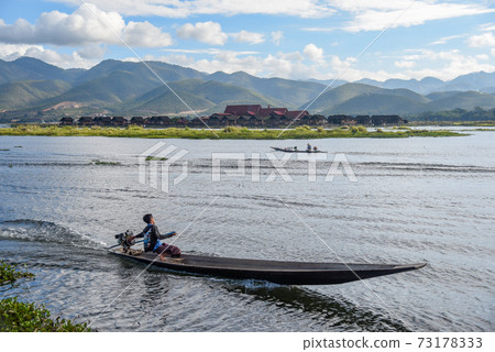 local man on the boat in Inle lake, Myanmar local man on the boat in Inle lake, Myanmar 73178333