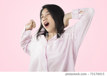 woman yawn and stretch when her wake up feeling sleepy. 73178915