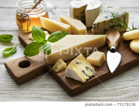 Various types of cheese on a white wooden background Various types of cheese on a white wooden background 73179136