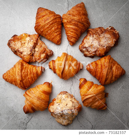 Fresh baked croissants on cement background. 73182337