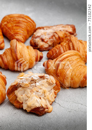 Fresh baked croissants on cement background. 73182342
