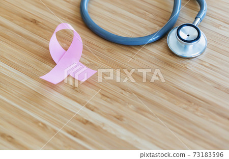 Pink ribbon and stethoscope on wooden background, closeup. Cancer concept Pink ribbon and stethoscope on wooden background, closeup. Cancer concept 73183596