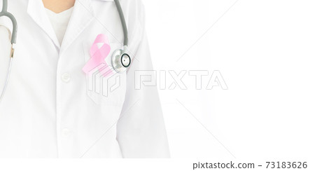 a young caucasian doctor woman with a pink ribbon for the breast cancer awareness pinned in the flap of his white coat 73183626