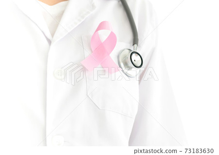 young caucasian doctor woman with a pink ribbon for the breast cancer awareness pinned in the flap of his white coat 73183630