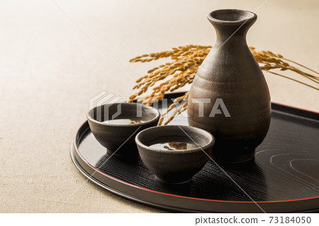 Sake poured into Ochoko Sake poured into Ochoko 73184050