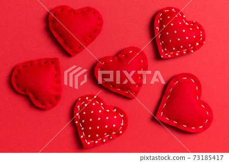 Composition of textile red hearts on colorful background. Close up view. Top view of St. Valentine's day concept Composition of textile red hearts on colorful background. Close up view. Top view of St. Valentine's day concept 73185417