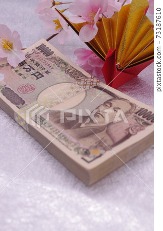 An image of a spring celebration or anniversary with origami celebration cranes and artificial flower cherry blossoms attached to the money wrapped in a traditional Japanese pattern strap 73187610