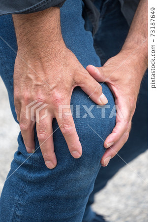 Knee sprain. Man suffering from knee pain 73187649