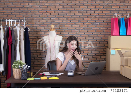 Young business woman working selling online. Surprise and shock face of asian woman success on making big sale of his online store. Online shopping 73188171
