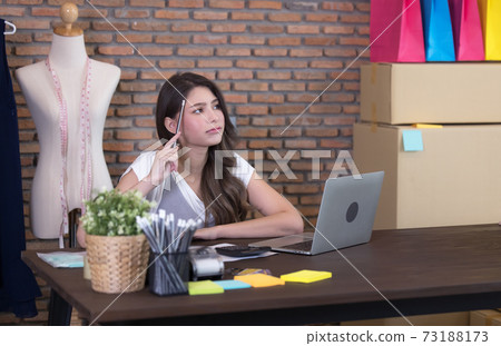 Young business woman working selling online. Surprise and shock face of asian woman success on making big sale of his online store. Online shopping Young business woman working selling online. Surprise and shock face of asian woman success on making big sale of his online store. Online shopping 73188173