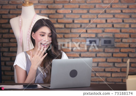 Young business woman working selling online. Surprise and shock face of asian woman success on making big sale of his online store. Online shopping Young business woman working selling online. Surprise and shock face of asian woman success on making big sale of his online store. Online shopping 73188174