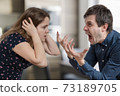 Divorce concept. Young angry couple arguing and shouting. 73189705