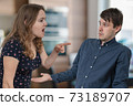 Jealousy hysterical wife is shouting and blaming her husband. 73189707