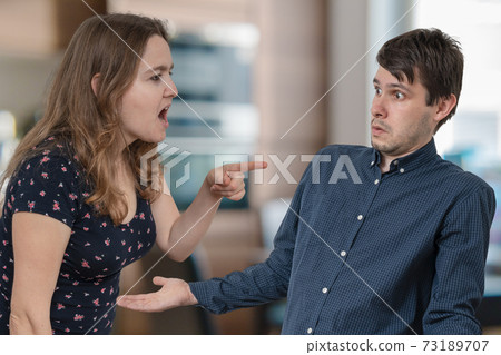 Jealousy hysterical wife is shouting and blaming her husband. Jealousy hysterical wife is shouting and blaming her husband. 73189707