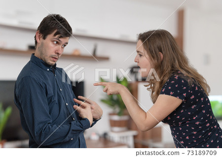 Jealousy hysterical woman is blaming and shouting on her husband Jealousy hysterical woman is blaming and shouting on her husband 73189709
