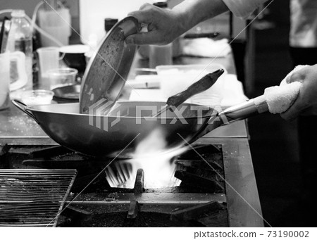 Chef cooking in a kitchen, chef at work, Black and White. Chef cooking in a kitchen, chef at work, Black and White. 73190002