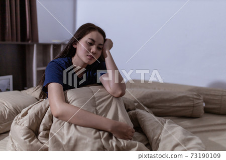 Young asian woman cannot sleep insomnia late at night. Can't sleep. Sleep apnea or stress. Sleep disorder concept. 73190109