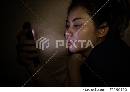 Closeup of asian women using smartphone at late night, Can't sleep. Sleep disorder concept.. 73190110