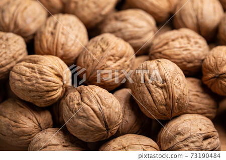 Whole Walnut closeup. Nuts background Whole Walnut closeup. Nuts background 73190484