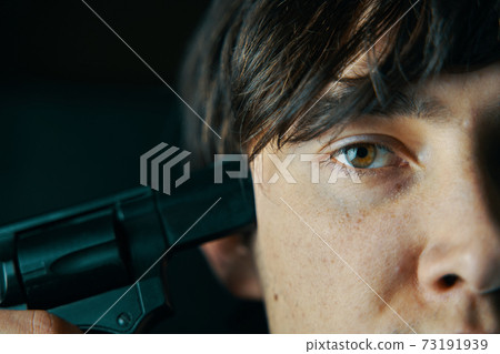 Man with gun is preparing to commit suicide. 73191939