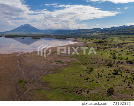 Aerial view on a Picturesque Coastline of Lake Natron in the Great Rift Valley, between Kenya and Tanzania. In the dry season the lake is 80% covered by soda and is known for its wading birds and huge Aerial view on a Picturesque Coastline of Lake Natron in the Great Rift Valley, between Kenya and Tanzania. In the dry season the lake is 80% covered by soda and is known for its wading birds and huge 73192855