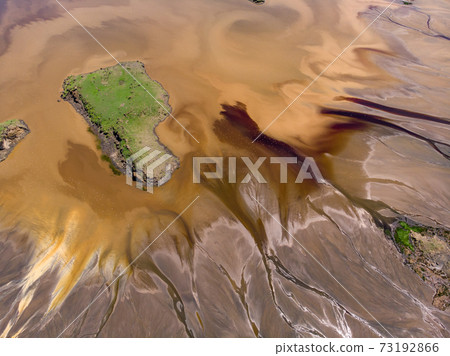 Aerial view on a Picturesque Coastline of Lake Natron in the Great Rift Valley, between Kenya and Tanzania. In the dry season the lake is 80% covered by soda and is known for its wading birds and huge Aerial view on a Picturesque Coastline of Lake Natron in the Great Rift Valley, between Kenya and Tanzania. In the dry season the lake is 80% covered by soda and is known for its wading birds and huge 73192866