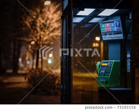 Public phone at night 73193158