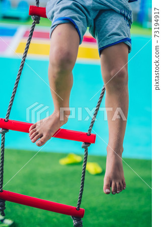 Shot Caucasian boy dirty legs toes foot calf knees sit on rope ladder down stairs outside playground Behavior, daycare summer, childhood care safety play, future direction growth education concept Shot Caucasian boy dirty legs toes foot calf knees sit on rope ladder down stairs outside playground Behavior, daycare summer, childhood care safety play, future direction growth education concept 73194917