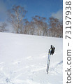Stock set up on a snowy field during a snowshoe hike in Kamikochi 73197938