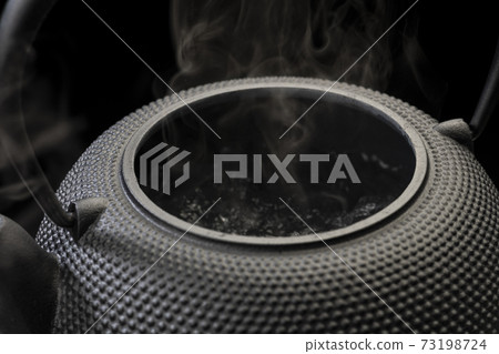 Boil water in an iron kettle 73198724