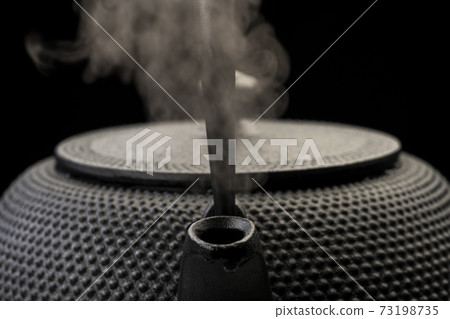 Boil water in an iron kettle Boil water in an iron kettle 73198735