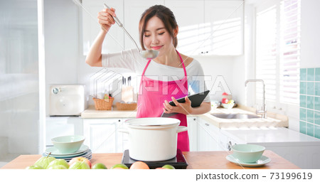 Asian housewife use tablet 73199619