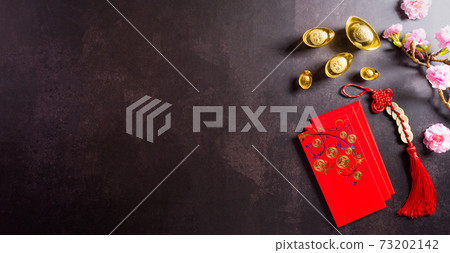 Chinese new year festival decorations pow or red packet, orange and gold ingots or golden lump on dark stone background. Chinese characters FU in the article refer to fortune good luck, wealth, money Chinese new year festival decorations pow or red packet, orange and gold ingots or golden lump on dark stone background. Chinese characters FU in the article refer to fortune good luck, wealth, money 73202142