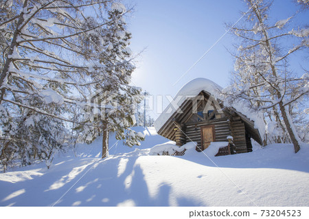 Snow-covered lodge on a sunny day Snow-covered lodge on a sunny day 73204523