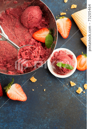 Homemade Fruit strawberry sorbet with mint in a bowl on wooden table, top view. Homemade Fruit strawberry sorbet with mint in a bowl on wooden table, top view. 73205464