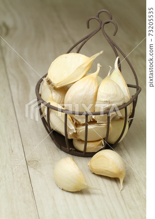 在一個小巧可愛的鐵絲網筐中放六片鬆散的大蒜 73205535