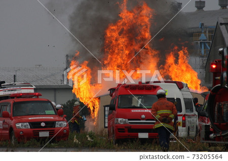 Burning flames during fire extinguishing training for building fires 73205564