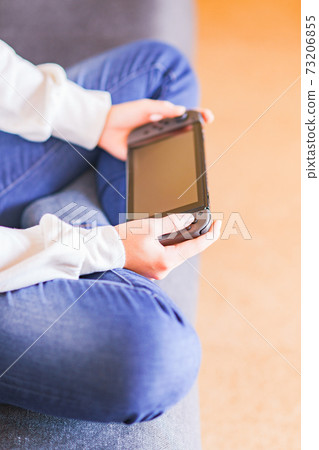 Teenager playing with a game controller [e-sports] 73206855