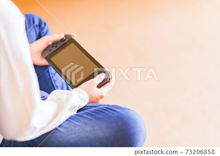 Teenager playing with a game controller [e-sports] 73206858