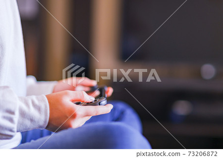 Teenager playing with a game controller [e-sports] 73206872