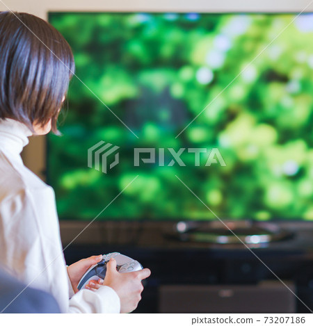 Teenager playing with a game controller [e-sports] 73207186