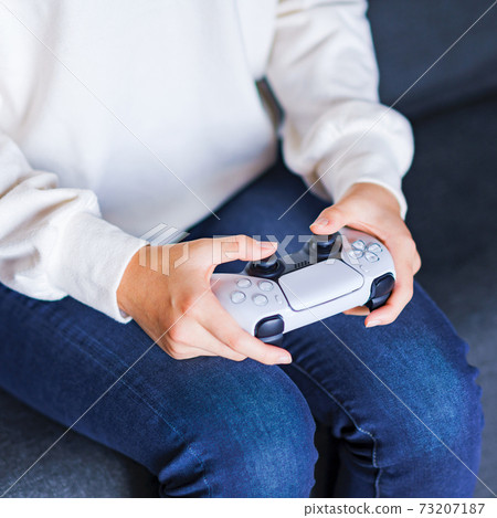 Teenager playing with a game controller [e-sports] 73207187