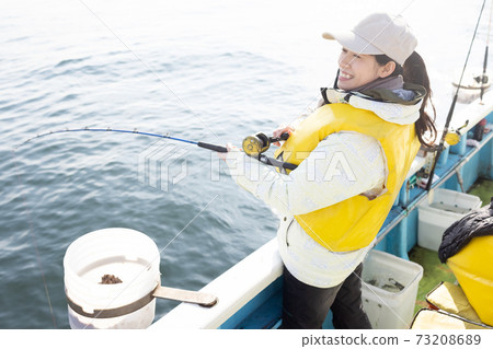 Cute woman enjoying fishing 73208689