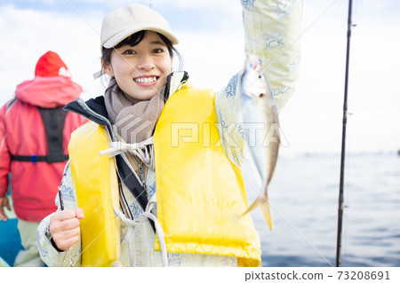 Cute woman enjoying fishing 73208691