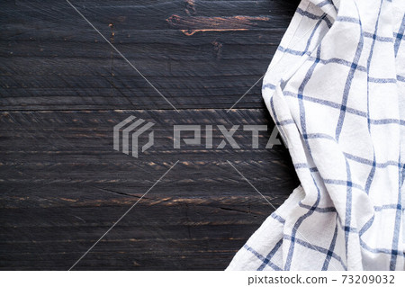 kitchen cloth (napkin) on wood background kitchen cloth (napkin) on wood background 73209032