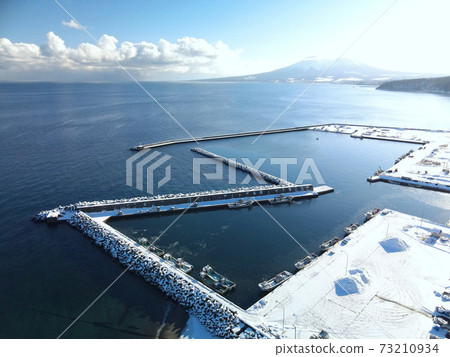 Aerial view of the snow scene of Ebiya fishing port in the morning in Mori-cho, Hokkaido in winter Aerial view of the snow scene of Ebiya fishing port in the morning in Mori-cho, Hokkaido in winter 73210934
