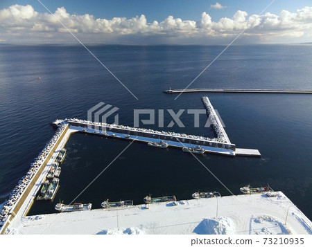 Aerial view of the snow scene of Ebiya fishing port in the morning in Mori-cho, Hokkaido in winter Aerial view of the snow scene of Ebiya fishing port in the morning in Mori-cho, Hokkaido in winter 73210935