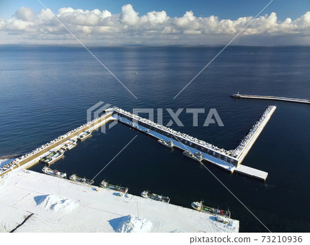 Aerial view of the snow scene of Ebiya fishing port in the morning in Mori-cho, Hokkaido in winter Aerial view of the snow scene of Ebiya fishing port in the morning in Mori-cho, Hokkaido in winter 73210936