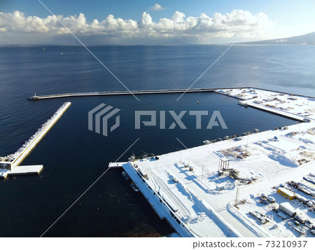 Aerial view of the snow scene of Ebiya fishing port in the morning in Mori-cho, Hokkaido in winter Aerial view of the snow scene of Ebiya fishing port in the morning in Mori-cho, Hokkaido in winter 73210937